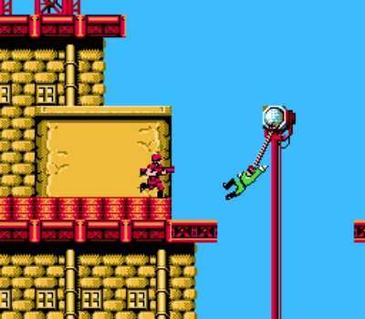 Bionic Commando screenshot of our hero trying his best to swing across a chasm with his bionic grappling hook hand that he wished was still a real hand so he could hold his children one last time